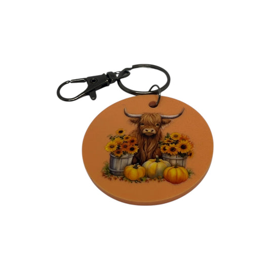 Highland cow with Orange pumpkins keyring